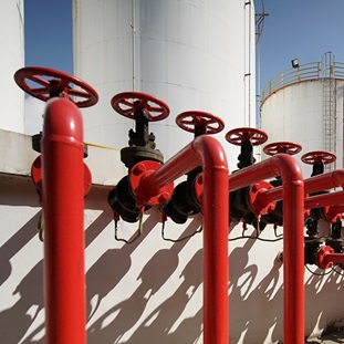 oil pipeline with red valves in oil refinery