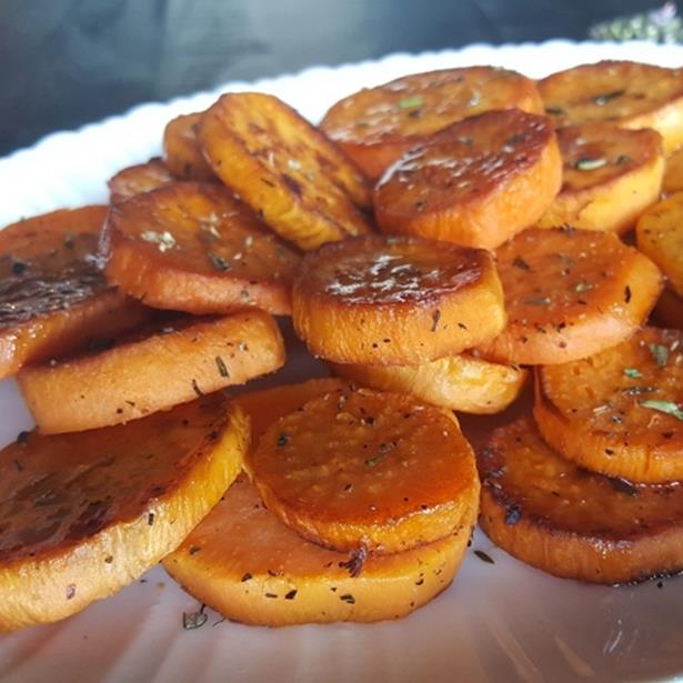 Caramelized sweet potato rounds on a dinner plate.