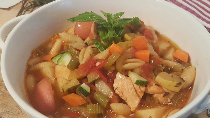 An image of the Summer Minestrone with Salmon in a bowl.