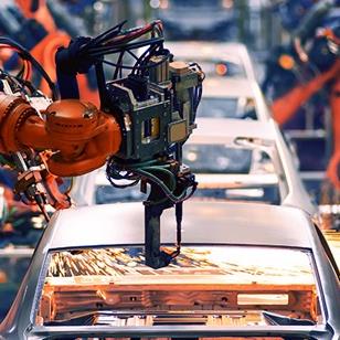 robot arm throwing sparks in automobile assembly line production