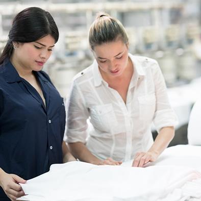two women examining clothing in the textile manufacturing industry