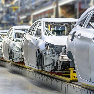 white cars on factory production assembly line