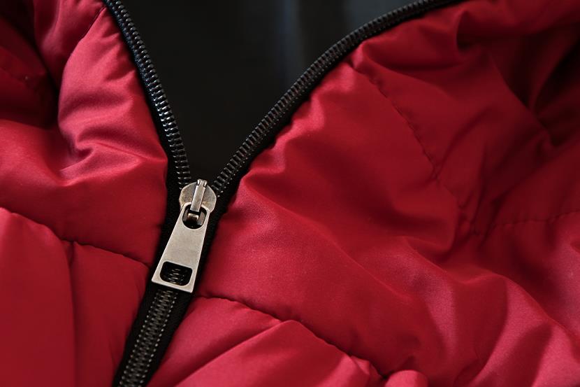 closeup of red partially unzipped down jacket