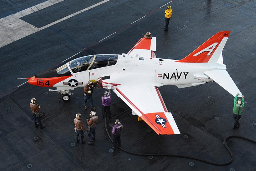 sailors refueling a t45 goshawk on flight deck