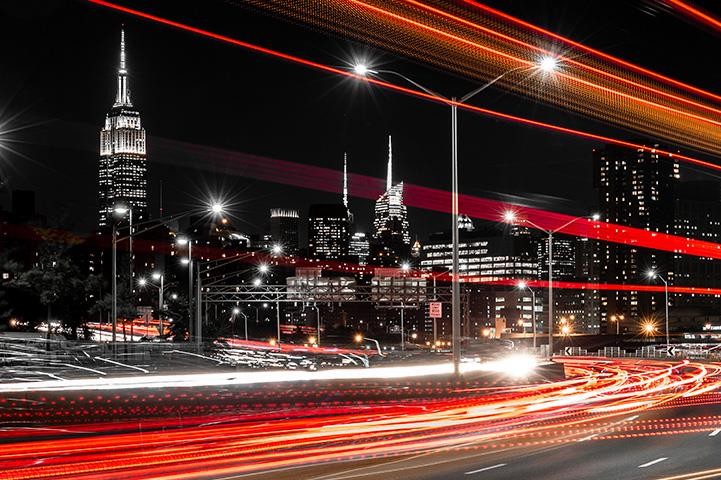 evening streetscape in nyc with blurred headlights and taillights