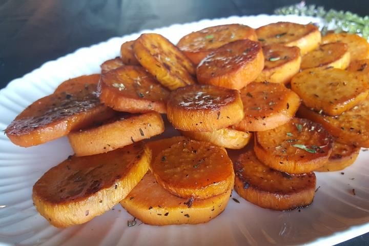 Caramelized sweet potato rounds on a dinner plate.