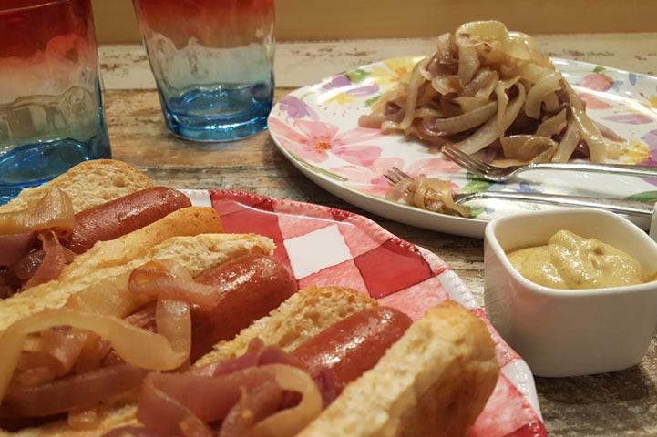 Hotdogs with onions on a plate